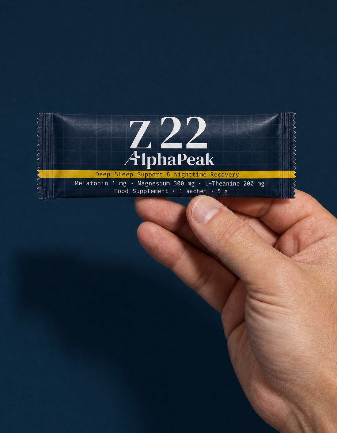 Hand holding an AlphaPeak Z22 sachet, Deep Sleep Support
